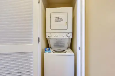 a washer and dryer in a corner of a room at Boardwalk Beach Resort #1605 by Book That Condo in Panama City Beach