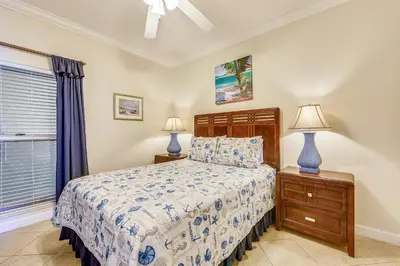 a bedroom with a bed and two lamps and a window at Boardwalk Beach Resort #1605 by Book That Condo in Panama City Beach