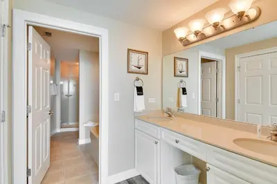 a bathroom with two sinks and a large mirror at Boardwalk Beach Resort #1703 by Book That Condo in Panama City Beach