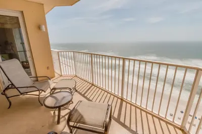 a balcony with chairs and a view of the ocean at Boardwalk Beach Resort #1703 by Book That Condo in Panama City Beach