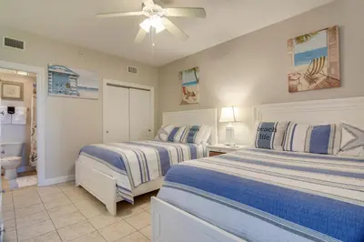 a bedroom with two beds and a ceiling fan at Boardwalk Beach Resort #1802 by Book That Condo in Panama City Beach
