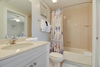 a bathroom with a sink and a toilet and a shower at Boardwalk Beach Resort #1802 by Book That Condo in Panama City Beach
