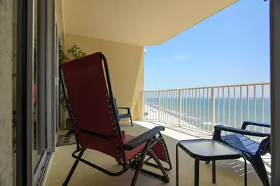 a balcony with chairs and a view of the ocean at Boardwalk Beach Resort #1802 by Book That Condo in Panama City Beach