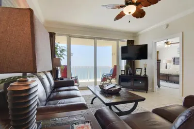 a living room with a couch and a tv at Boardwalk Beach Resort #1802 by Book That Condo in Panama City Beach