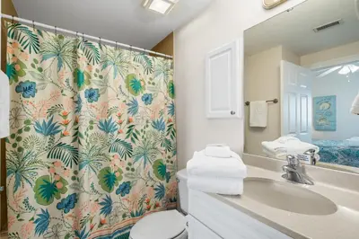a bathroom with a sink and a shower curtain at Boardwalk Beach Resort #1909 by Book That Condo in Panama City Beach