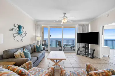 a living room with a couch and a flat screen tv at Boardwalk Beach Resort #1909 by Book That Condo in Panama City Beach