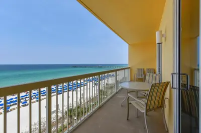 a balcony with a table and chairs and a view of the beach at Calypso Resort and Towers #602-E by Book That Condo in Panama City Beach