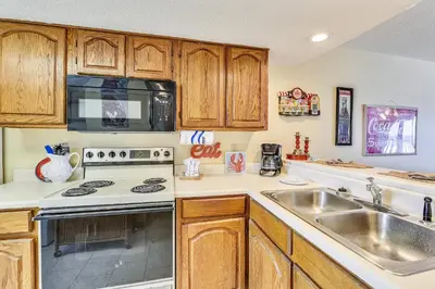 a kitchen with a sink and a stove at Commodore Resort #703 by Book That Condo in Panama City Beach