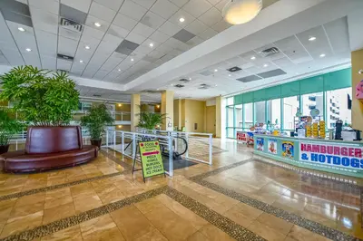 a lobby with a restaurant with a food counter at Emerald Beach #636 by Book That Condo in Panama City Beach