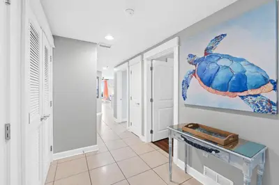 a hallway with a painting of a turtle on the wall at Grand Panama Beach Resort #406-1 by Book That Condo in Panama City Beach