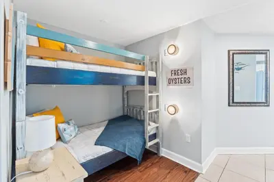 a bedroom with bunk beds in a house at Grand Panama Beach Resort #406-1 by Book That Condo in Panama City Beach