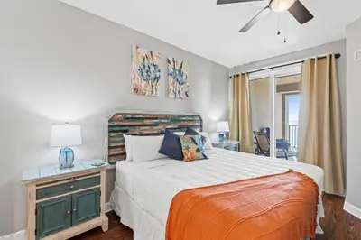 a bedroom with a bed and a desk and a window at Grand Panama Beach Resort #406-1 by Book That Condo in Panama City Beach