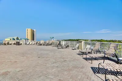 a group of chairs sitting on top of a patio at Grand Panama Beach Resort #406-1 by Book That Condo in Panama City Beach