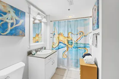 a bathroom with a painting of an octopus on the shower curtain at Grand Panama Beach Resort #406-1 by Book That Condo in Panama City Beach