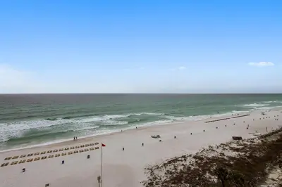 a group of people on a beach near the ocean at Ocean Villa Condos #801 by Book That Condo in Panama City Beach