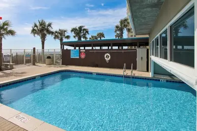a large swimming pool in front of a building at Ocean Villa Condos #801 by Book That Condo in Panama City Beach