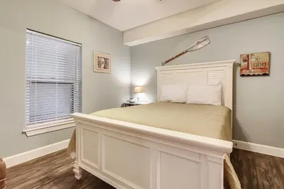 a bedroom with a white bed and a window at Ocean Villa Condos #801 by Book That Condo in Panama City Beach