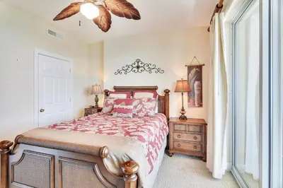 a bedroom with a large bed and a window at Ocean Villa Condos #1801 by Book That Condo in Panama City Beach