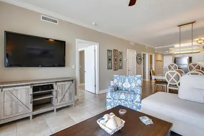 a living room with a large flat screen tv at Twin Palms Resort #404 by Book That Condo in Panama City Beach