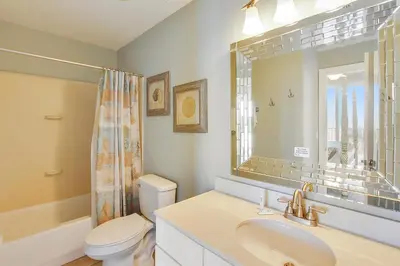 a bathroom with a sink and a toilet and a mirror at Twin Palms Resort #404 by Book That Condo in Panama City Beach