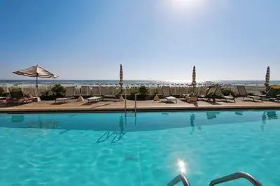a large swimming pool with chairs and umbrellas at Twin Palms Resort #404 by Book That Condo in Panama City Beach