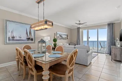 a dining room and living room with a table and chairs at Twin Palms Resort #404 by Book That Condo in Panama City Beach