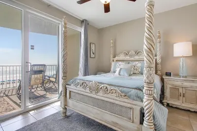 a bedroom with a bed and a balcony at Twin Palms Resort #404 by Book That Condo in Panama City Beach