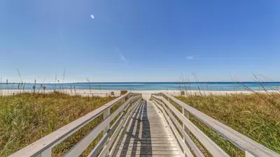 a boardwalk to the beach with the ocean in the background at Twin Palms Resort #601 by Book That Condo in Panama City Beach