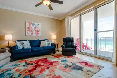 a living room with a blue couch and a chair at Twin Palms Resort #601 by Book That Condo in Panama City Beach