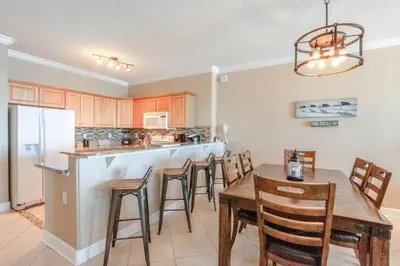 a kitchen and dining room with a table and chairs at Twin Palms Resort #601 by Book That Condo in Panama City Beach