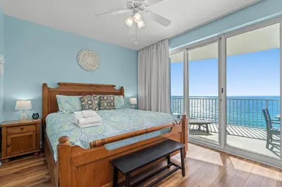 a bedroom with a bed with a view of the ocean at Twin Palms Resort #1605 by Book That Condo in Panama City Beach