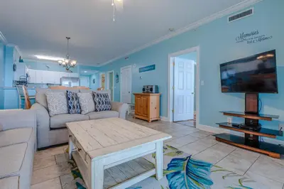 a living room with a couch and a tv at Twin Palms Resort #1605 by Book That Condo in Panama City Beach