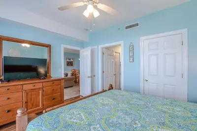 a bedroom with a bed and a flat screen tv at Twin Palms Resort #1605 by Book That Condo in Panama City Beach