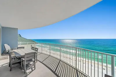 a balcony with a table and chairs and the ocean at Twin Palms Resort #1605 by Book That Condo in Panama City Beach