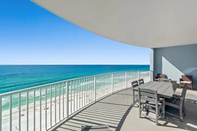 a balcony with a table and chairs on the beach at Twin Palms Resort #1605 by Book That Condo in Panama City Beach