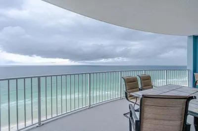 a balcony with a table and chairs and the ocean at Twin Palms Resort #1605 by Book That Condo in Panama City Beach