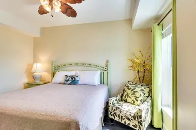 a bedroom with a bed and a chair at Twin Palms Resort #1905 by Book That Condo in Panama City Beach