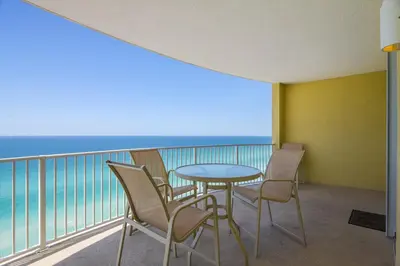 a balcony with a table and chairs and the ocean at Twin Palms Resort #1905 by Book That Condo in Panama City Beach