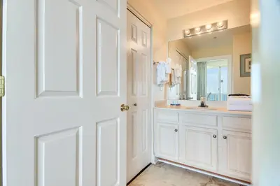 a white bathroom with a sink and a mirror at Twin Palms Resort #1905 by Book That Condo in Panama City Beach