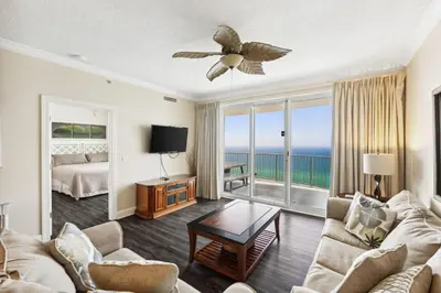 a living room with a couch and a bed at Twin Palms Resort #1905 by Book That Condo in Panama City Beach