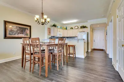 a kitchen and dining room with a table and chairs at Twin Palms Resort #1905 by Book That Condo in Panama City Beach
