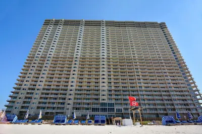 a large building with chairs and a beach at Tidewater Beach Resort #508 by Book That Condo in Panama City Beach