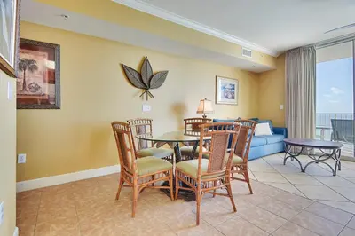 a living room with a table and chairs and a couch at Tidewater Beach Resort #2014 by Book That Condo in Panama City Beach