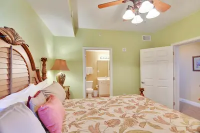 a bedroom with a bed and a ceiling fan at Tidewater Beach Resort #2014 by Book That Condo in Panama City Beach