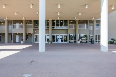 an empty courtyard of a large building with columns at Tidewater Beach Resort #2014 by Book That Condo in Panama City Beach