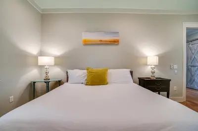 a bedroom with a large white bed with two lamps at 30A Blue Crab Cottage by Panhandle Getaways in Rosemary Beach