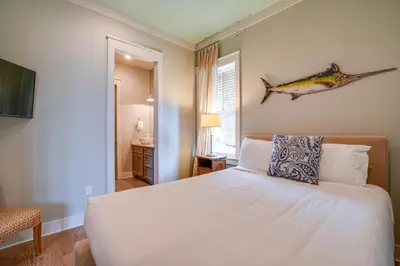 a bedroom with a bed with a fish on the wall at 30A Blue Crab Cottage by Panhandle Getaways in Rosemary Beach
