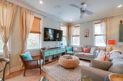 a living room with a couch and a tv at 30A Blue Crab Cottage by Panhandle Getaways in Rosemary Beach