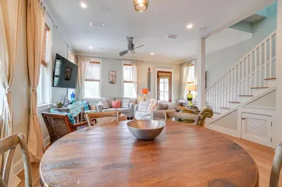 a dining room with a wooden table and a living room at 30A Blue Crab Cottage by Panhandle Getaways in Rosemary Beach
