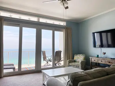 a living room with a view of the ocean at Laketown Wharf 2118 in Panama City Beach